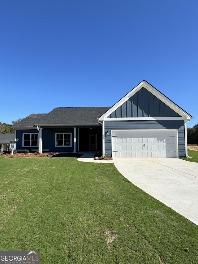 single story home featuring a garage and a front lawn