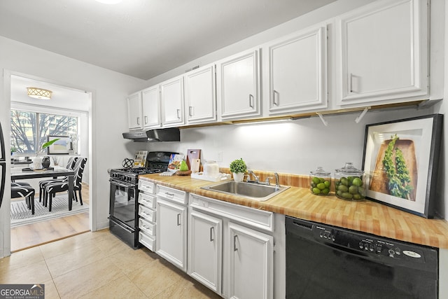 kitchen featuring white cabinets, light tile patterned floors, sink, and black appliances