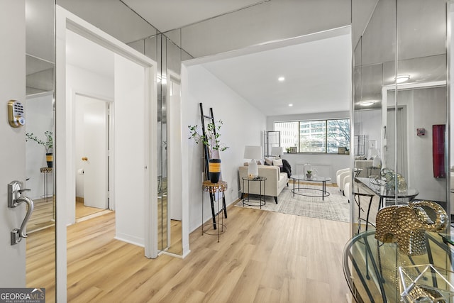 hallway with light hardwood / wood-style flooring