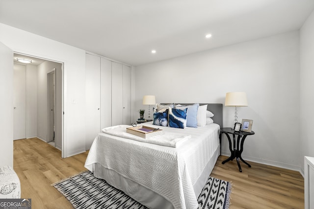 bedroom featuring a closet and light hardwood / wood-style flooring