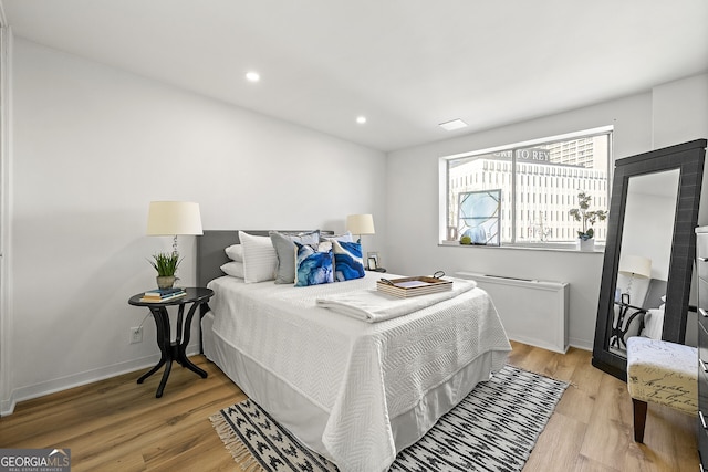 bedroom with light hardwood / wood-style flooring