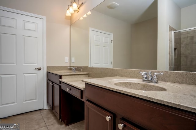 bathroom featuring tile patterned flooring, vanity, and walk in shower