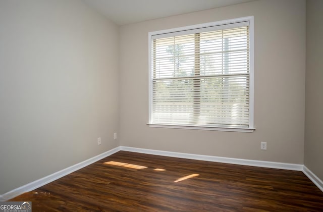 unfurnished room with dark hardwood / wood-style floors