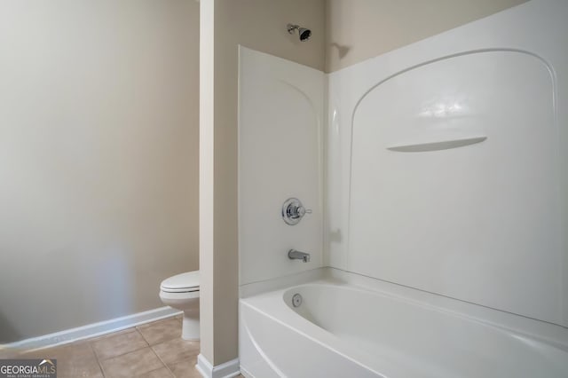 bathroom with tile patterned floors, toilet, and shower / washtub combination