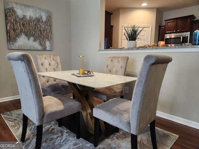 dining space featuring dark hardwood / wood-style floors