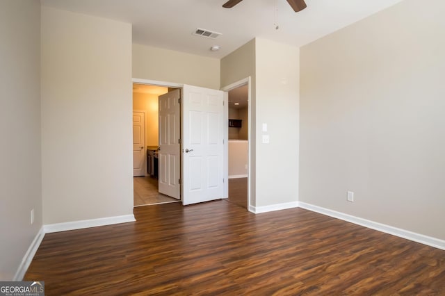 unfurnished bedroom with ceiling fan and dark hardwood / wood-style flooring