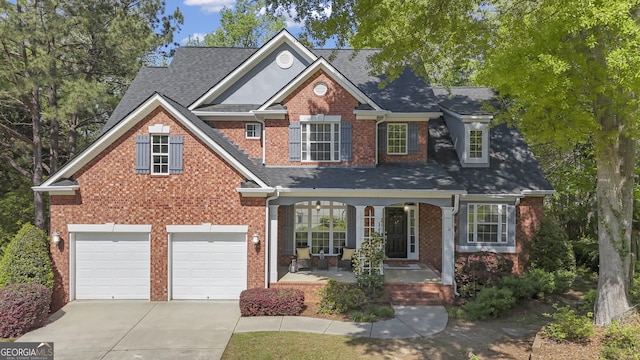 traditional-style home with concrete driveway, roof with shingles, a porch, brick siding, and a garage