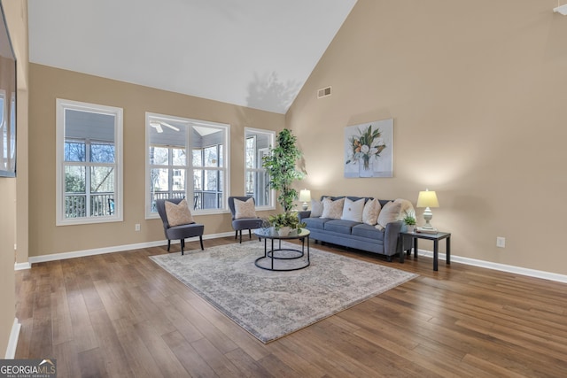 living room with wood finished floors, baseboards, visible vents, and plenty of natural light