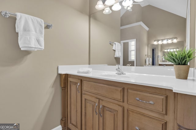 bathroom with vanity and vaulted ceiling
