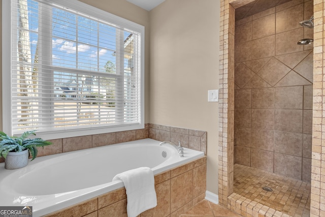 bathroom with a bath, a shower stall, tile patterned flooring, and a healthy amount of sunlight