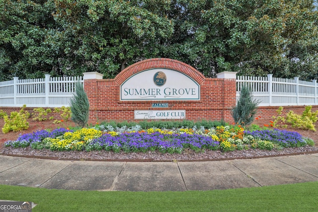 community sign featuring fence