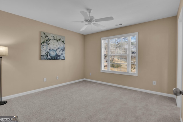 spare room with visible vents, baseboards, and carpet flooring