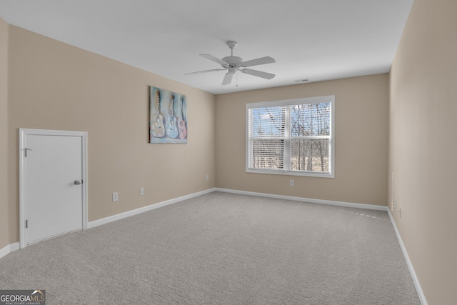 carpeted empty room with baseboards and ceiling fan