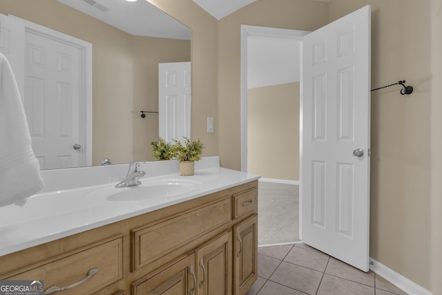 bathroom featuring tile patterned floors, vanity, and baseboards