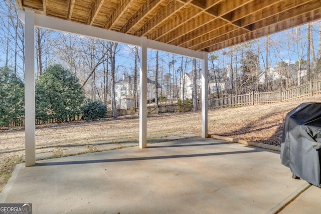 view of patio with fence and a grill