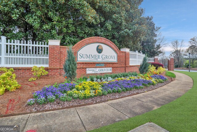 community sign featuring fence