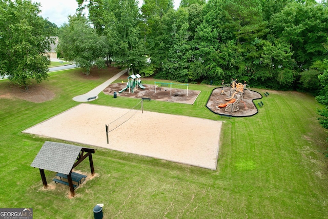 surrounding community featuring a yard, playground community, and volleyball court
