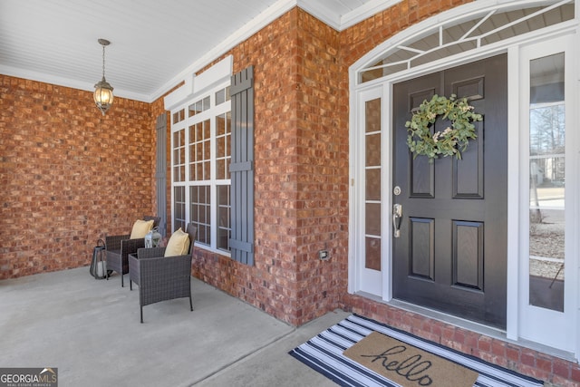 property entrance with brick siding and a porch