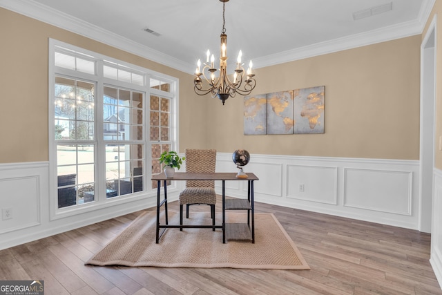 office featuring a chandelier, visible vents, ornamental molding, and a wainscoted wall