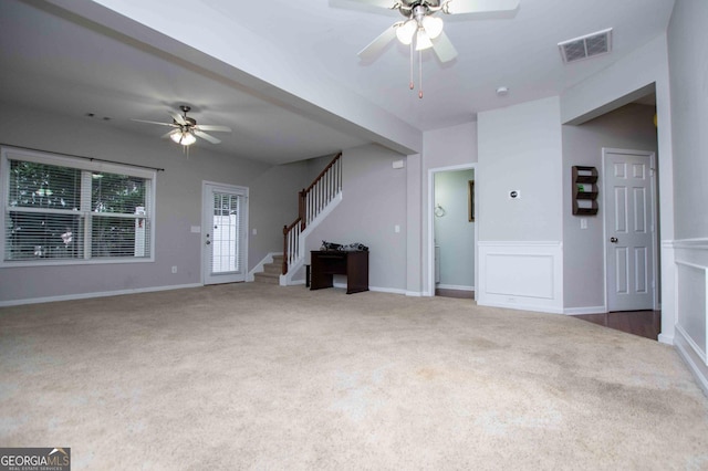 unfurnished living room with carpet floors and ceiling fan