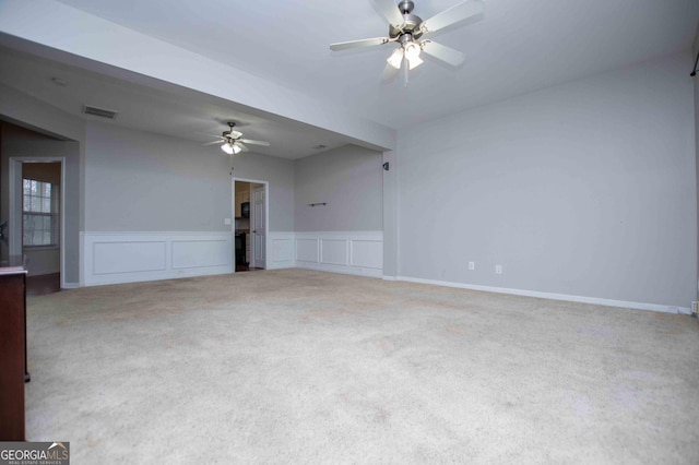 spare room with ceiling fan and carpet