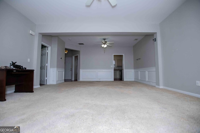 unfurnished living room featuring ceiling fan and carpet