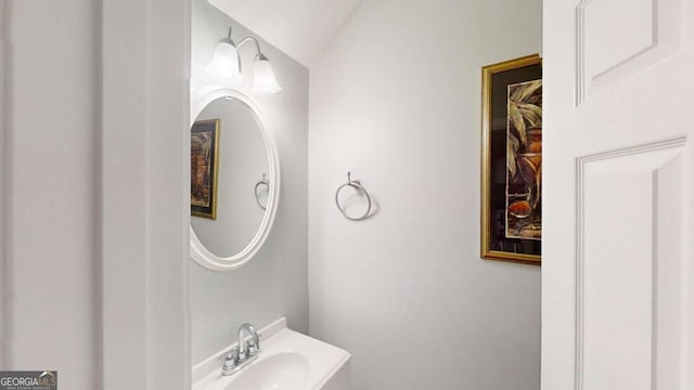 bathroom with vaulted ceiling and sink