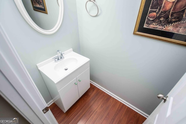 bathroom with hardwood / wood-style flooring and vanity