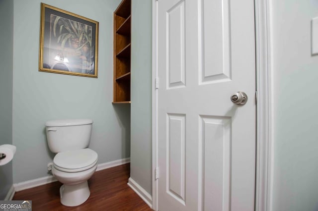 bathroom featuring wood-type flooring and toilet