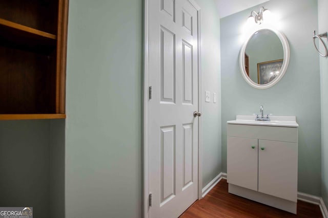 bathroom with hardwood / wood-style flooring and vanity