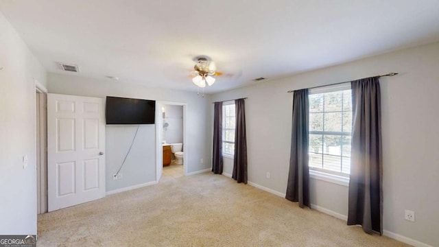 carpeted empty room with a healthy amount of sunlight and ceiling fan