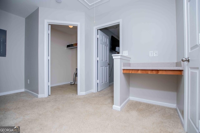 hall featuring light colored carpet and electric panel