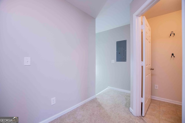 hall featuring light carpet and electric panel