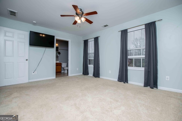 unfurnished bedroom with light carpet and ensuite bath