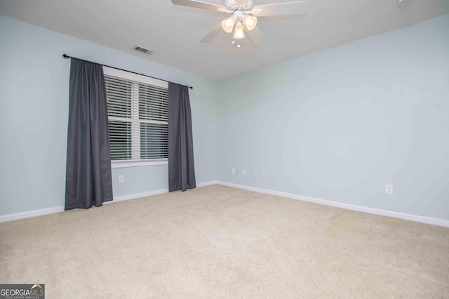 carpeted spare room featuring ceiling fan