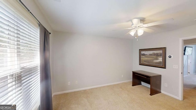 carpeted spare room with ceiling fan