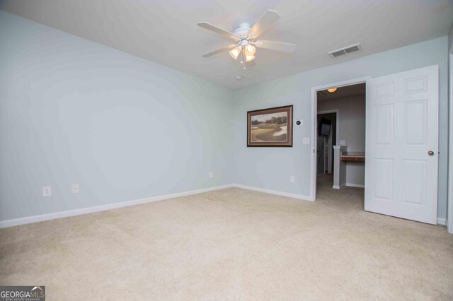 unfurnished bedroom with ceiling fan and light colored carpet