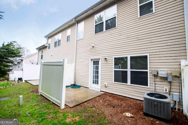 rear view of property with a patio and cooling unit