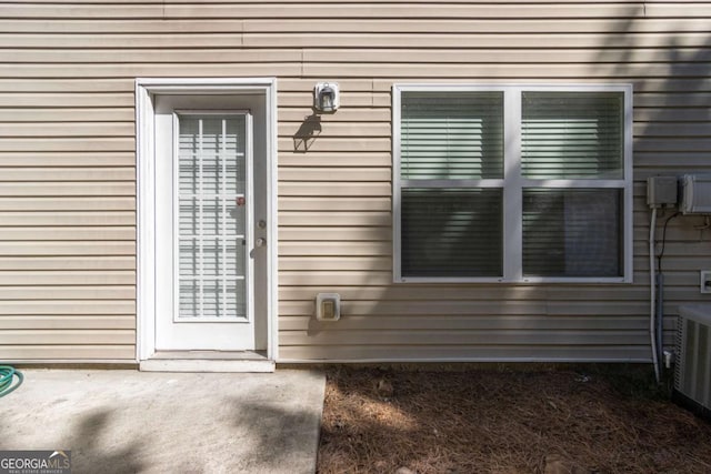 entrance to property featuring cooling unit