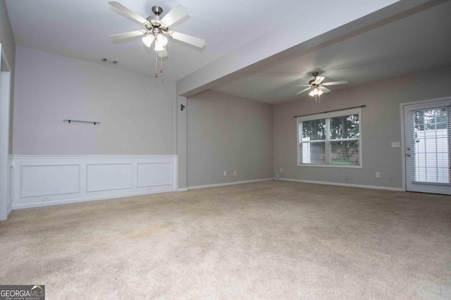 spare room with light colored carpet and ceiling fan