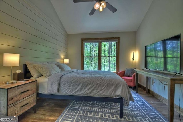 bedroom with dark wood-type flooring, ceiling fan, and vaulted ceiling