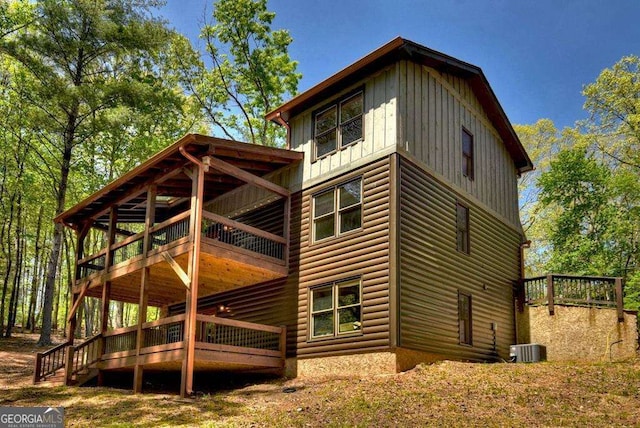 view of side of home featuring a balcony and central air condition unit