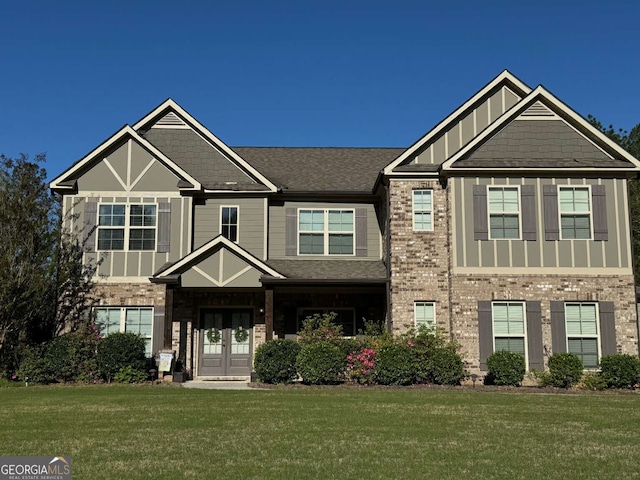 craftsman-style house featuring a front lawn and french doors