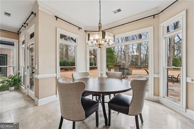 sunroom / solarium with a wealth of natural light and a notable chandelier