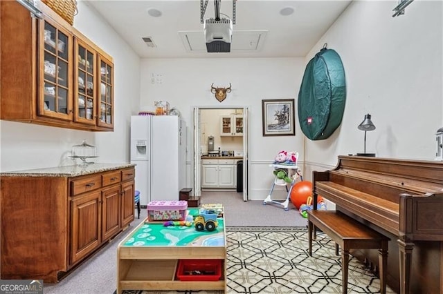 game room with light colored carpet