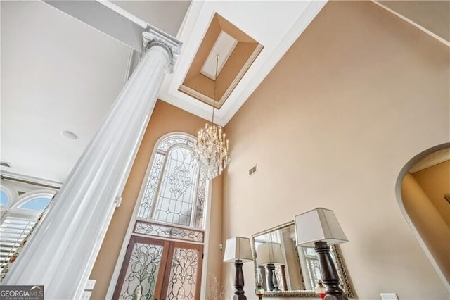 foyer featuring a high ceiling, a chandelier, and french doors