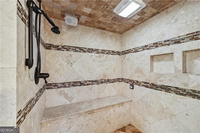 interior details with a tile shower