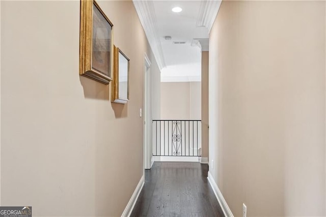 corridor with ornamental molding and dark wood-type flooring