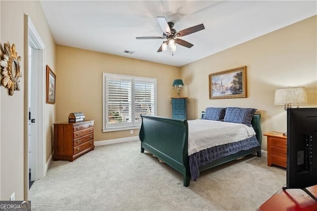 bedroom with light carpet and ceiling fan