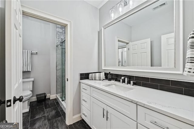 bathroom featuring vanity, toilet, and walk in shower